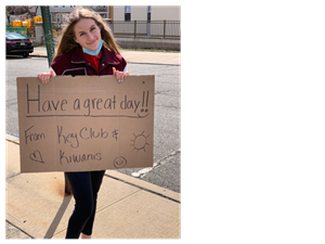 Key Club Student holding sign 